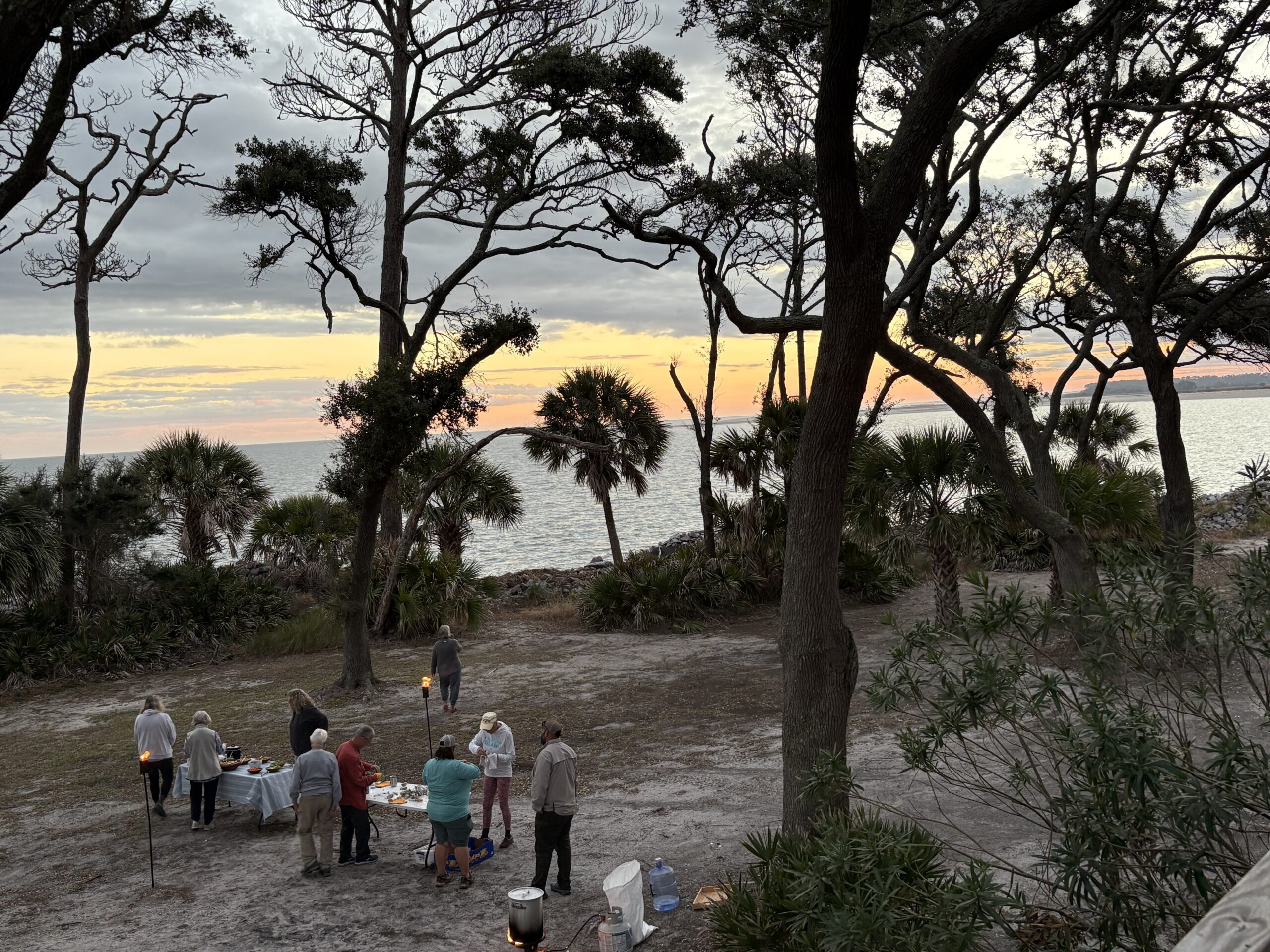 People enjoying an oyster roast on St. Phillips Island